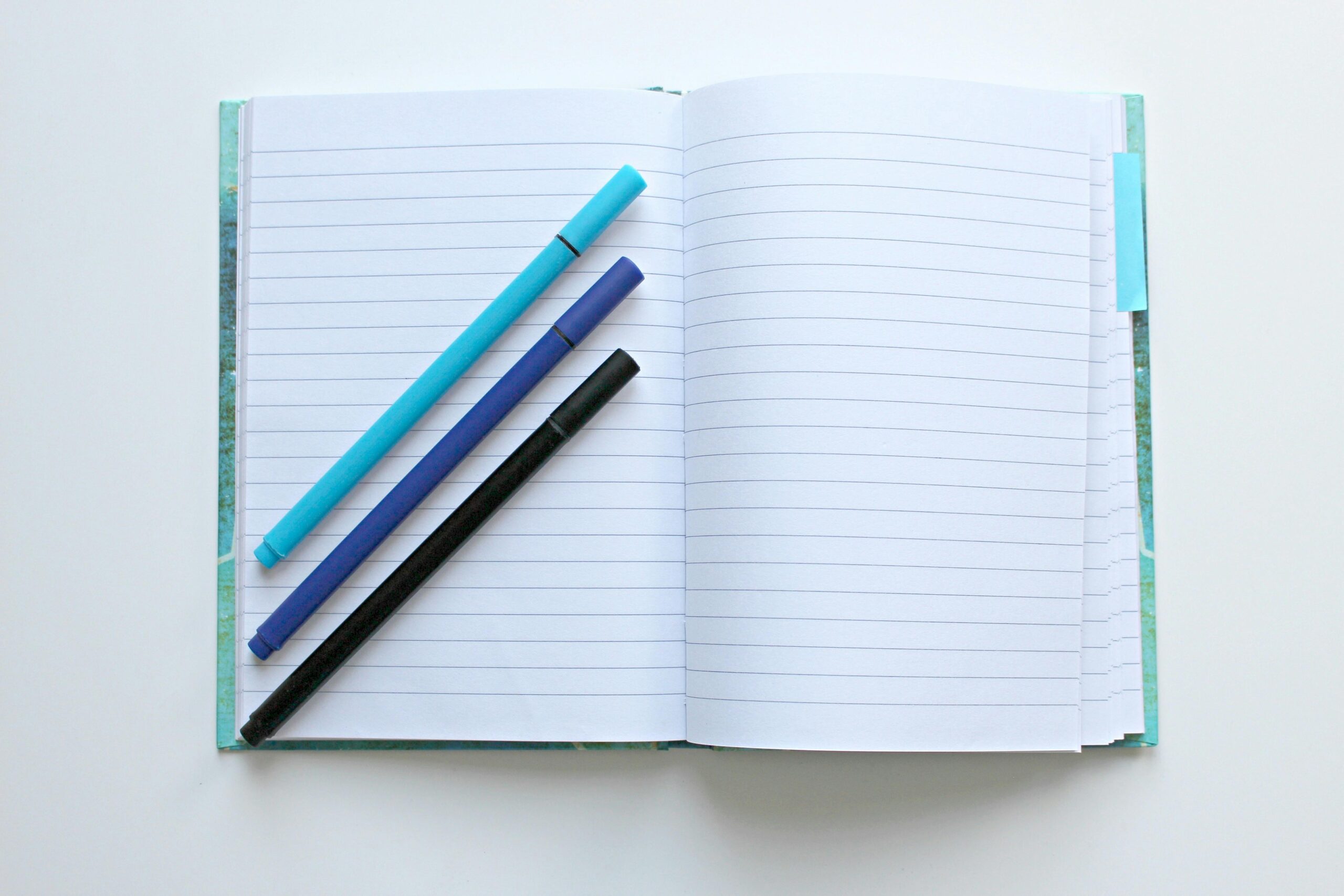 An open journal with pens, used for reflecting and processing after narcissistic abuse