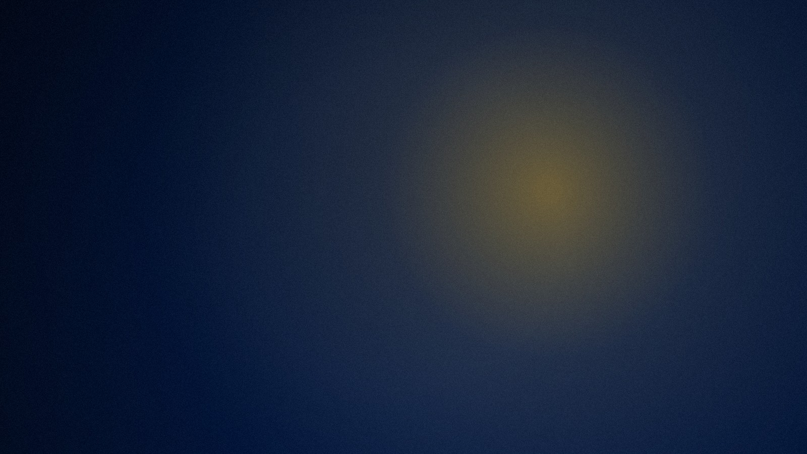 A single warm light in a dark room, the beginning of self-compassion