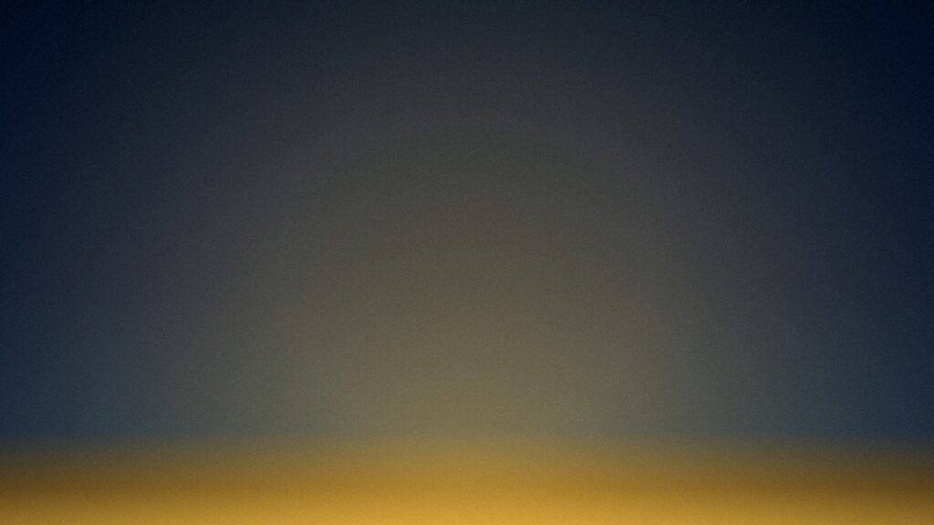 A soft gold horizon under deep navy, the quieting of a harsh inner voice